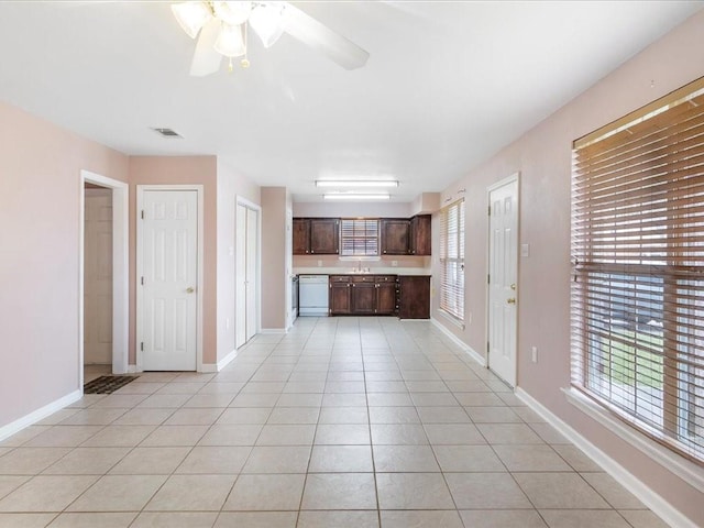 kitchen with dark brown cabinets, white dishwasher, ceiling fan, and light tile patterned flooring