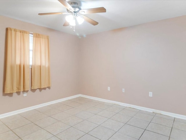 spare room featuring ceiling fan and light tile patterned flooring