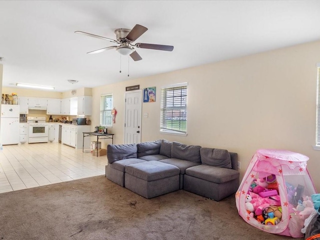 living room with ceiling fan and light colored carpet