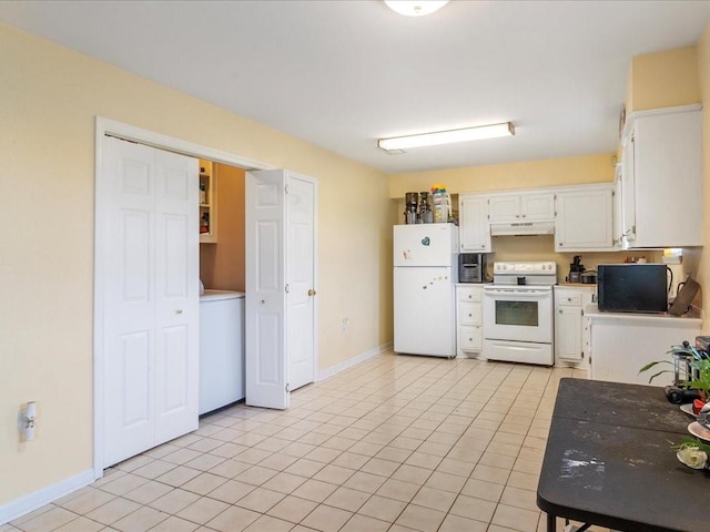 kitchen featuring white appliances, washer / clothes dryer, white cabinetry, and light tile patterned flooring