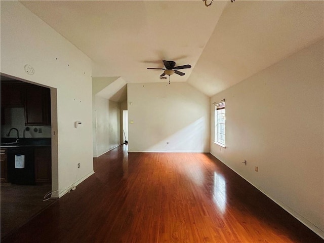 unfurnished living room with dark hardwood / wood-style floors, ceiling fan, lofted ceiling, and sink