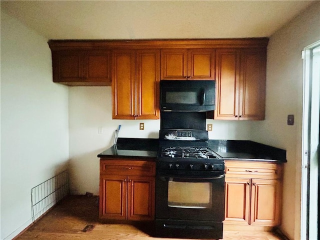 kitchen featuring black appliances and light hardwood / wood-style floors