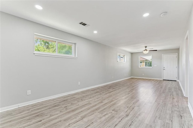 unfurnished room featuring ceiling fan, light hardwood / wood-style flooring, and a wealth of natural light