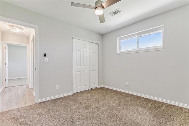 unfurnished bedroom featuring ceiling fan, carpet, and a closet