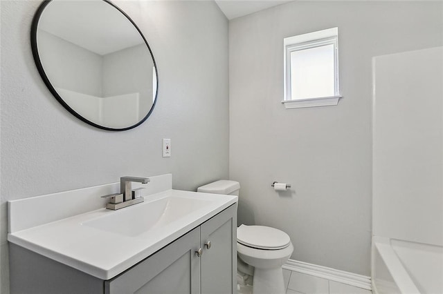 bathroom featuring vanity, tile patterned floors, and toilet