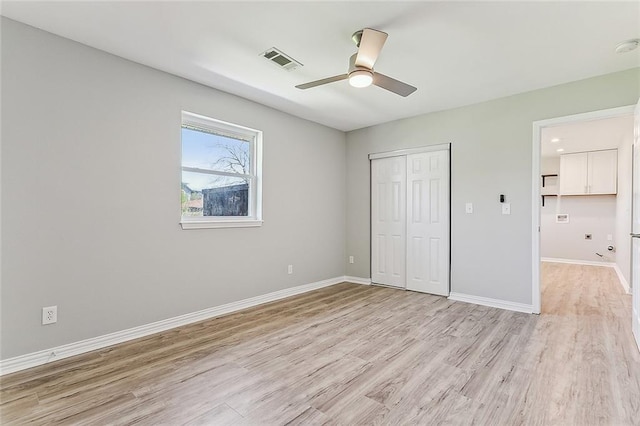 unfurnished bedroom with ceiling fan, a closet, and light hardwood / wood-style flooring