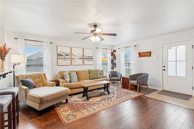 living room featuring dark hardwood / wood-style flooring, plenty of natural light, and ceiling fan