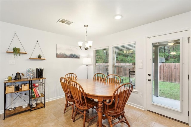 dining room featuring a notable chandelier and light tile patterned floors