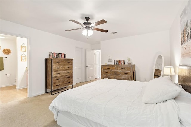 carpeted bedroom featuring ensuite bath and ceiling fan