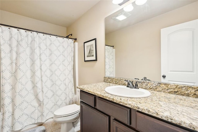 bathroom with tile patterned flooring, a shower with curtain, vanity, and toilet