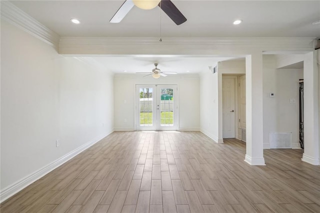 unfurnished room featuring light hardwood / wood-style floors, ornate columns, ornamental molding, and french doors