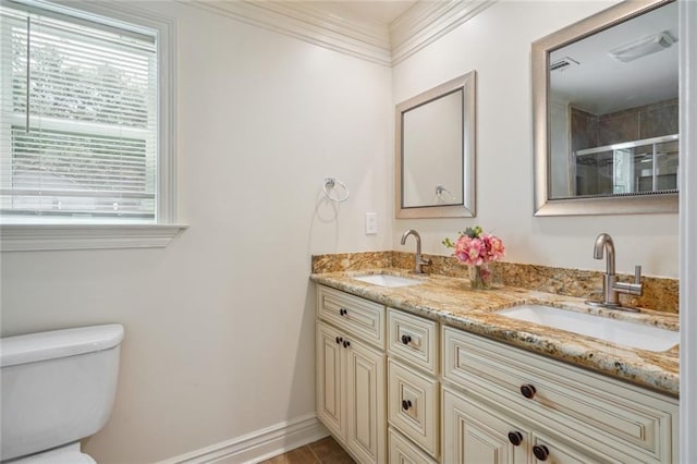 bathroom with vanity, ornamental molding, a shower with shower door, and toilet