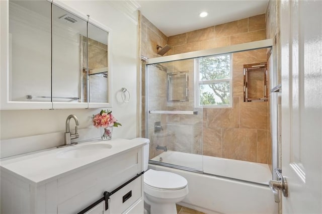 full bathroom with shower / bath combination with glass door, vanity, and toilet