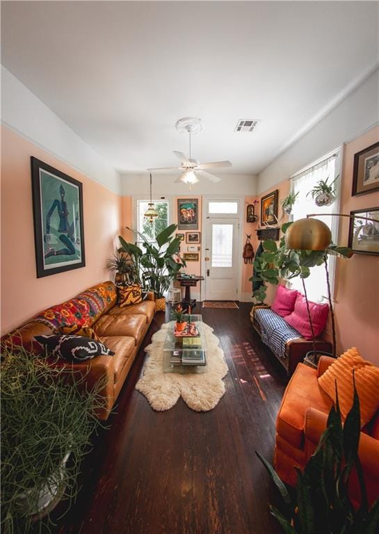 living room featuring hardwood / wood-style flooring and ceiling fan