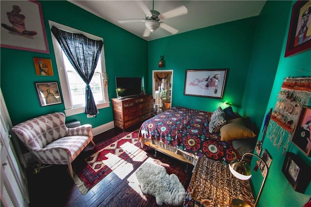 bedroom with hardwood / wood-style floors and ceiling fan