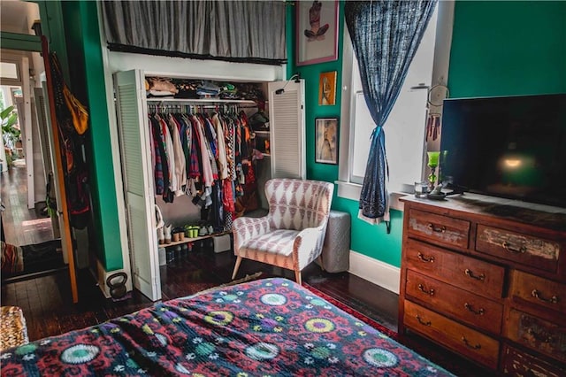 bedroom with a closet and dark wood-type flooring