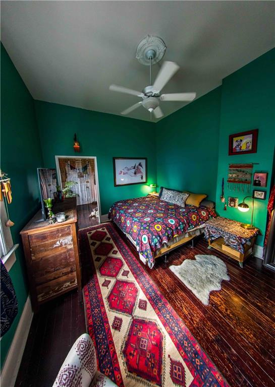 bedroom featuring ceiling fan and hardwood / wood-style flooring