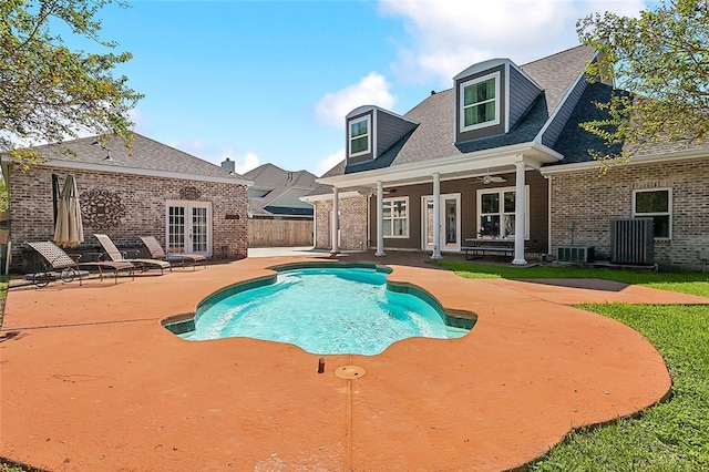 view of swimming pool featuring french doors, central AC unit, ceiling fan, and a patio area