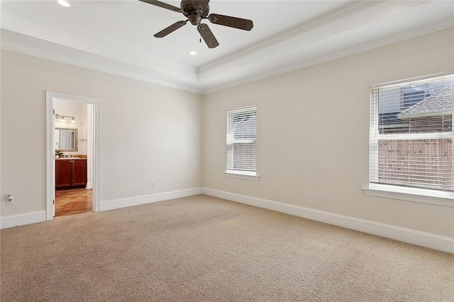 empty room with light colored carpet, a wealth of natural light, ornamental molding, and ceiling fan