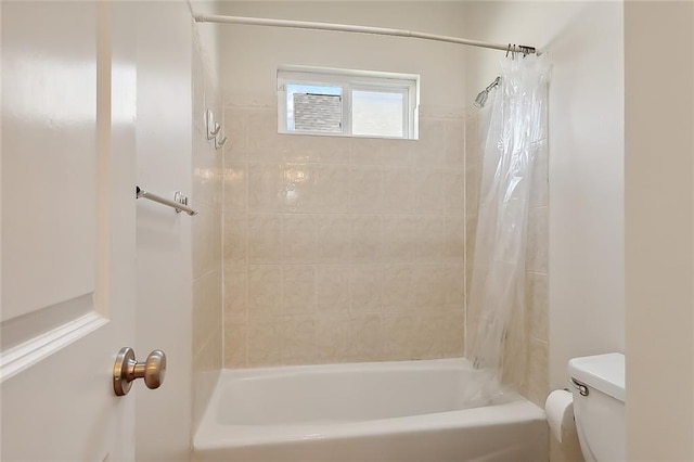 bathroom with shower / bath combination with curtain and toilet