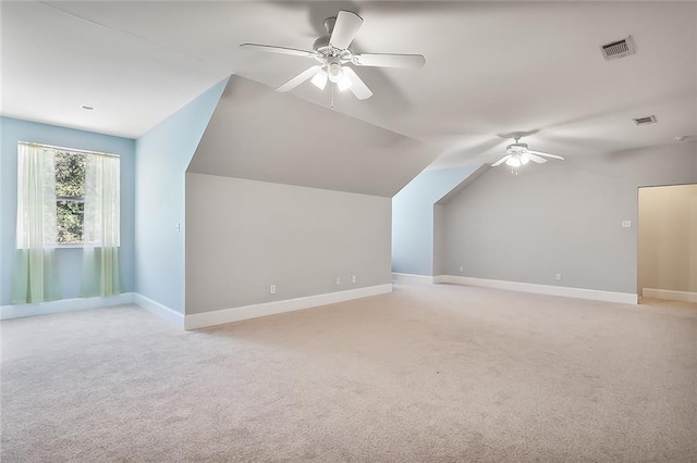 additional living space featuring light colored carpet, vaulted ceiling, and ceiling fan