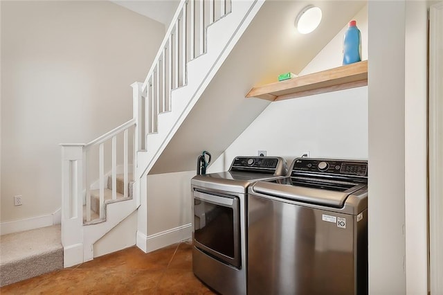 clothes washing area with dark carpet and washing machine and dryer