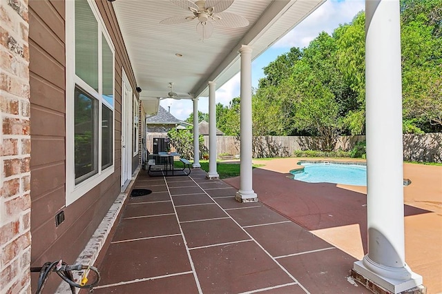 view of patio featuring a fenced in pool and ceiling fan