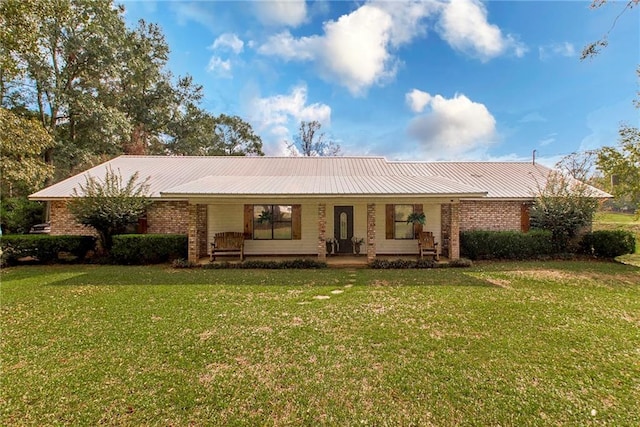 back of house featuring a lawn and a porch