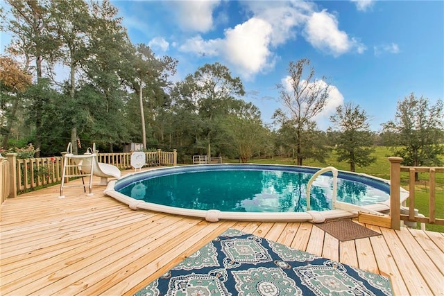 view of swimming pool with a deck