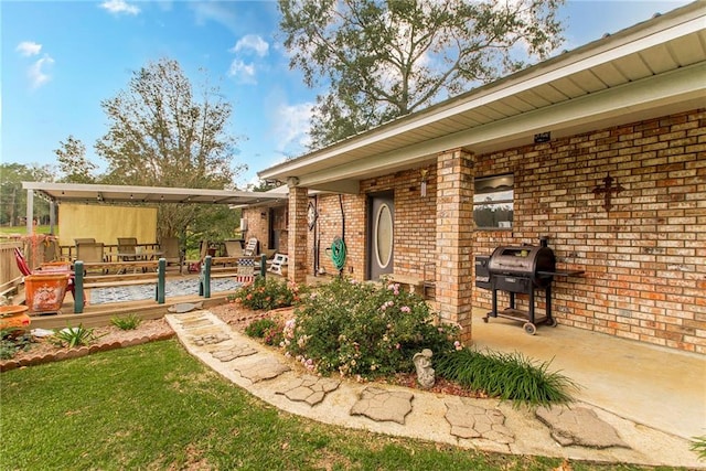 view of patio with grilling area and a wooden deck