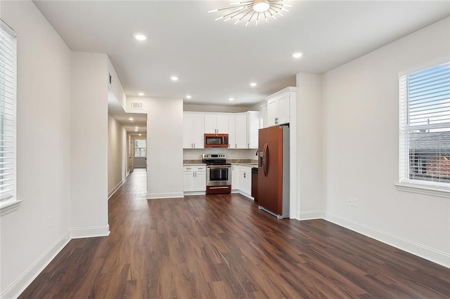 kitchen featuring dark wood-type flooring, stainless steel range with electric cooktop, white cabinetry, dishwasher, and refrigerator with ice dispenser