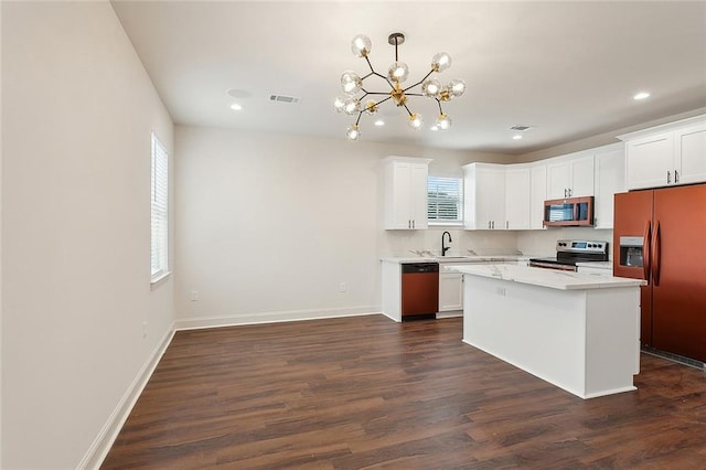 kitchen featuring white cabinetry, hanging light fixtures, a kitchen island, and appliances with stainless steel finishes