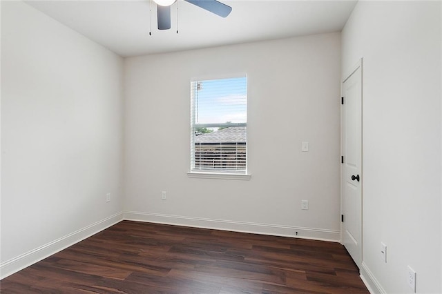 empty room featuring dark wood-type flooring and ceiling fan