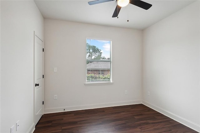 empty room featuring dark hardwood / wood-style flooring and ceiling fan