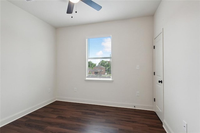 spare room with dark hardwood / wood-style flooring and ceiling fan