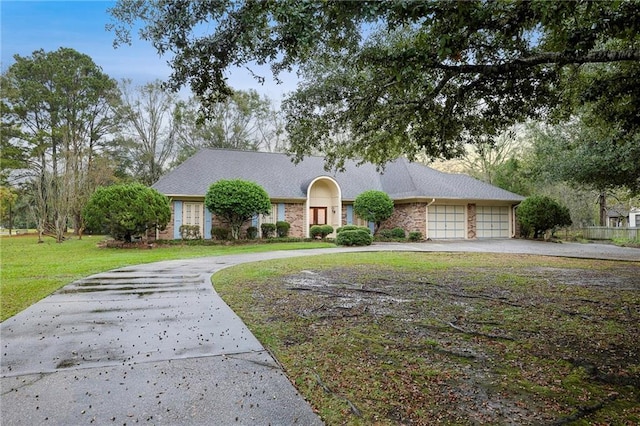 view of front of house with a garage and a front yard