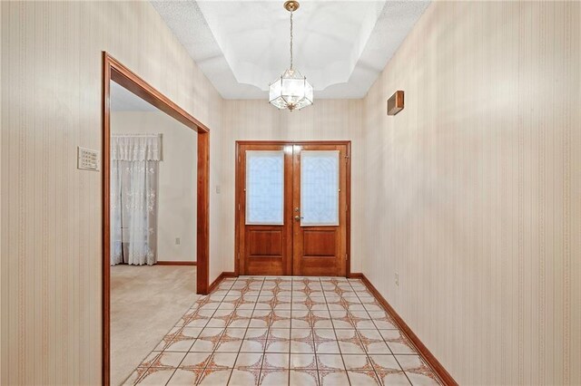 1391 E Ashton Ct, Slidell, LA 70460 - foyer entrance featuring french doors, a chandelier, baseboards, and a tray ceiling