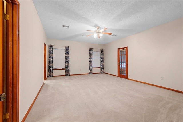 1391 E Ashton Ct, Slidell, LA 70460 - spare room with light carpet, a ceiling fan, baseboards, and a textured ceiling