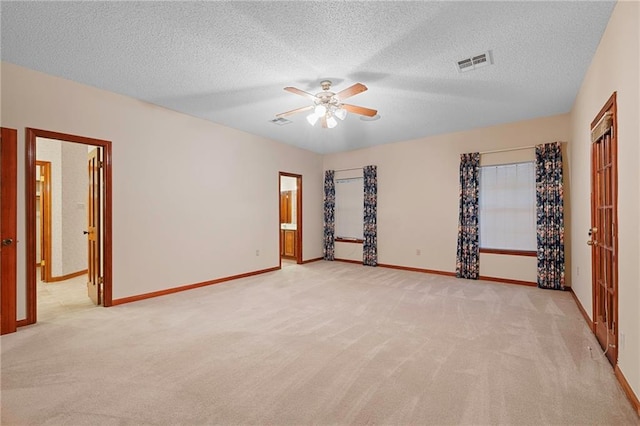 1391 E Ashton Ct, Slidell, LA 70460 - spare room with light colored carpet, ceiling fan, baseboards, and a textured ceiling