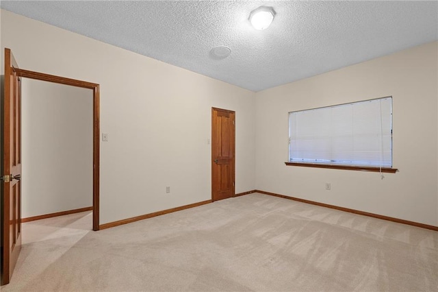 1391 E Ashton Ct, Slidell, LA 70460 - unfurnished room featuring light colored carpet, baseboards, and a textured ceiling