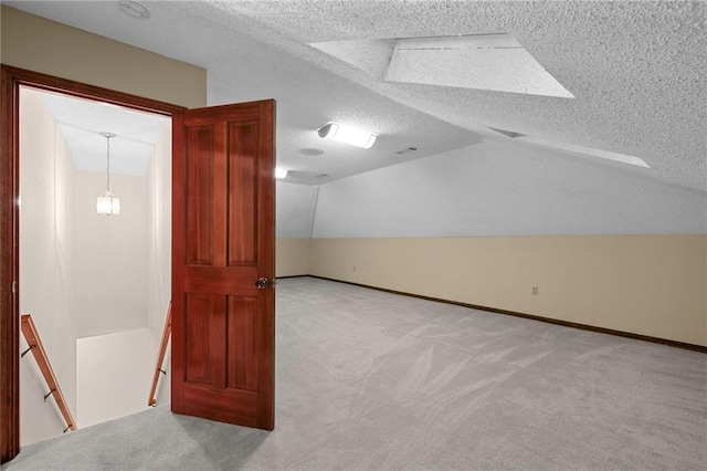 1391 E Ashton Ct, Slidell, LA 70460 - bonus room with carpet, vaulted ceiling, a textured ceiling, and baseboards