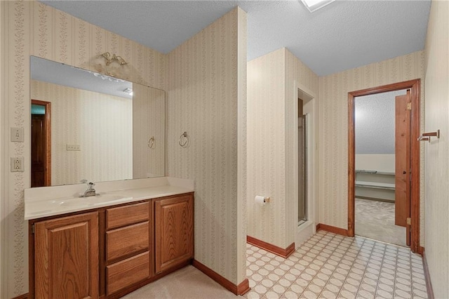 1391 E Ashton Ct, Slidell, LA 70460 - full bathroom featuring vanity, a textured ceiling, baseboards, and a shower with door