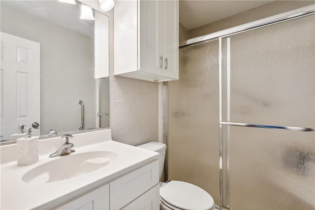 bathroom with vanity, toilet, and walk in shower