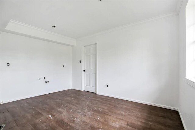 empty room with dark hardwood / wood-style floors and ornamental molding