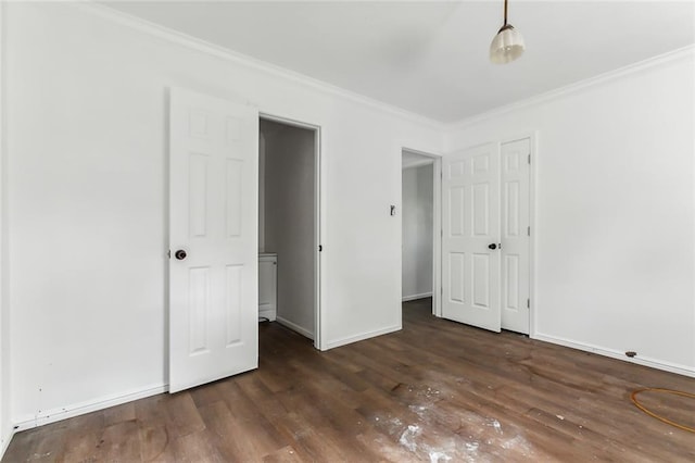 unfurnished bedroom featuring dark wood-type flooring and crown molding