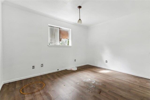 unfurnished room with dark hardwood / wood-style flooring