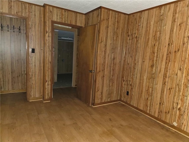 empty room featuring hardwood / wood-style floors and wood walls