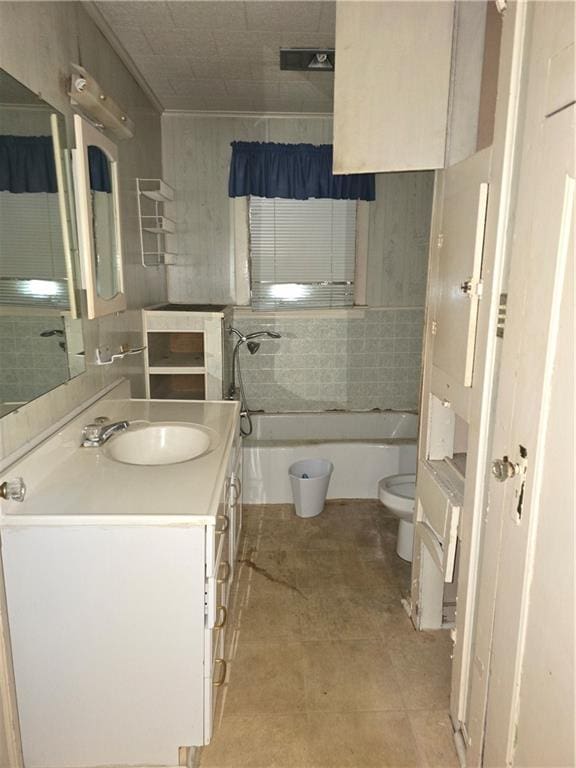 bathroom featuring tile patterned flooring, vanity, tile walls, and toilet