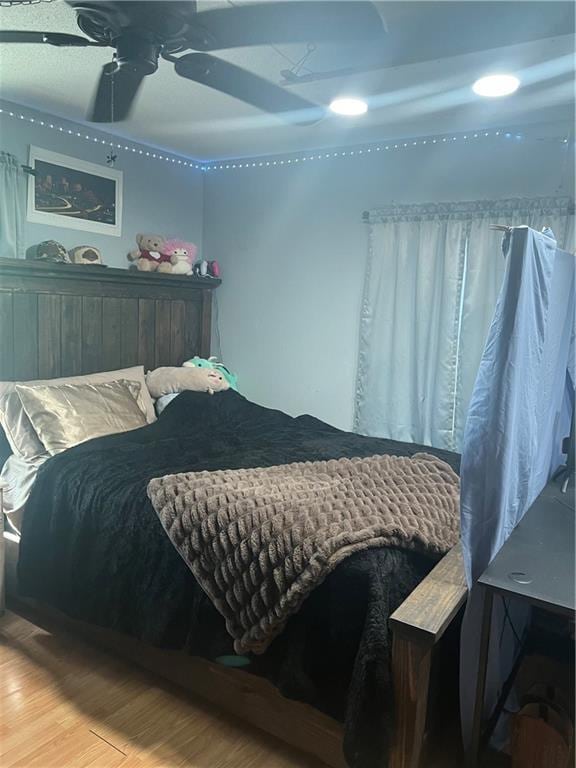 bedroom featuring hardwood / wood-style flooring and ceiling fan