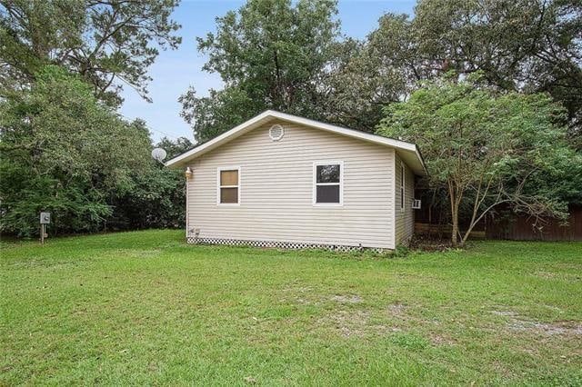 view of side of property with a yard